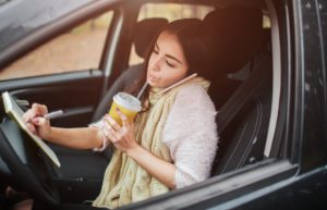 Woman driving distracted to work