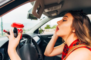 Young woman distracted driving in car