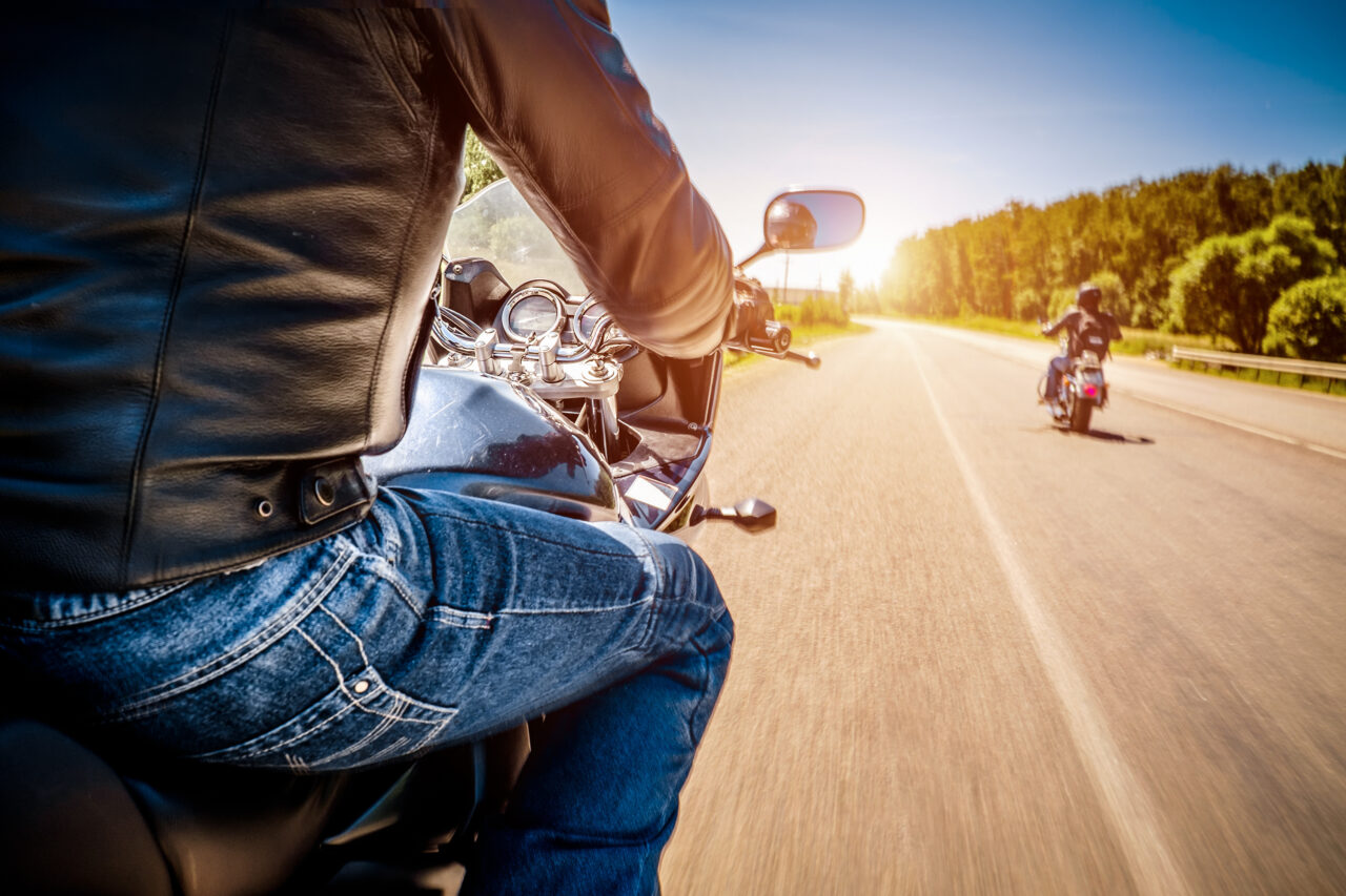 biker riding motorcycle on highway