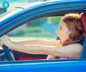 Stressed woman behind the steering wheel - Stress Awareness Month