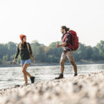 Young couple with rucksacks walking on National Walking Day