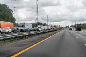 Interstate highway i95 driving car pov in Florida and traffic jam of many trucks vehicles stuck due to accident on road