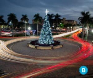 Christmas tree lit up in middle of roundabout in Florida.