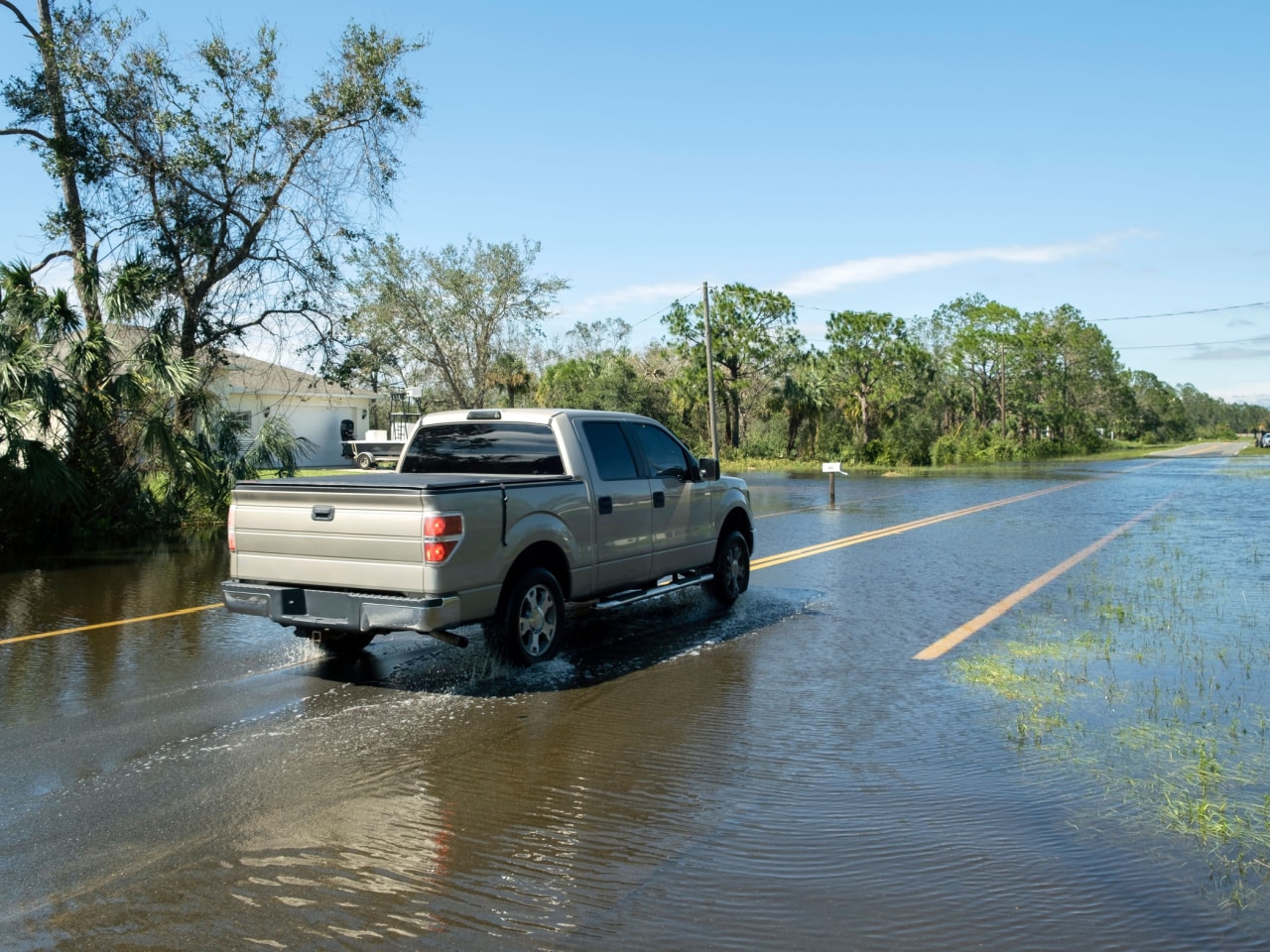 truck driving on flooded road