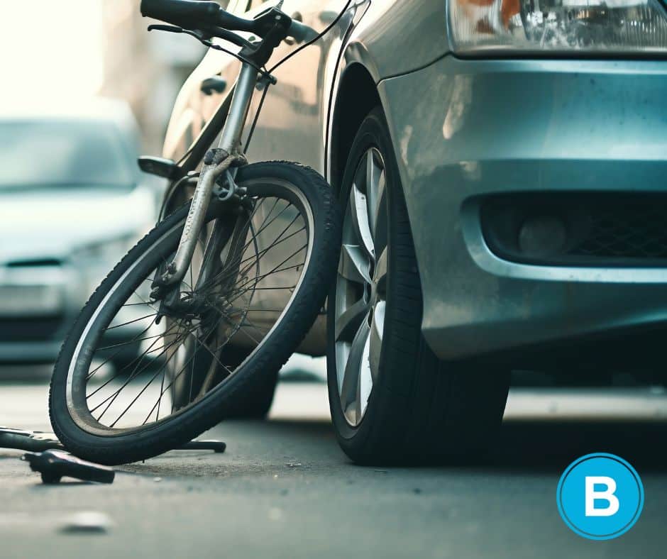 damaged bicycle propped against car after collision accident