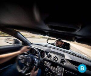 man steering car and car swerving while driving