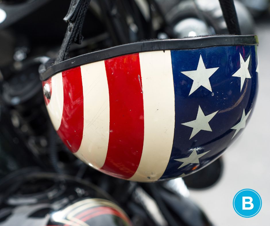 American Flag printed motorcycle helmet hanging on handle of motorcycle. Were you injured in Tampa Bay on Memorial Day?