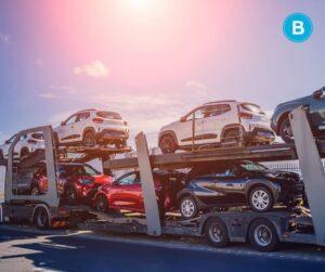 fully loaded car hauler rig with sunset in background