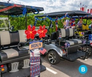 golf carts parked beside each other, decorated for 4th of July