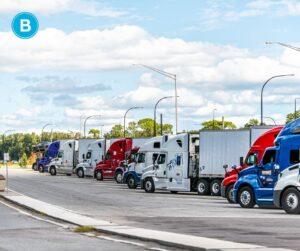 Semi-trucks lined up in parking area of Orlando rest stop. Truck accident Orlando injury attorney
