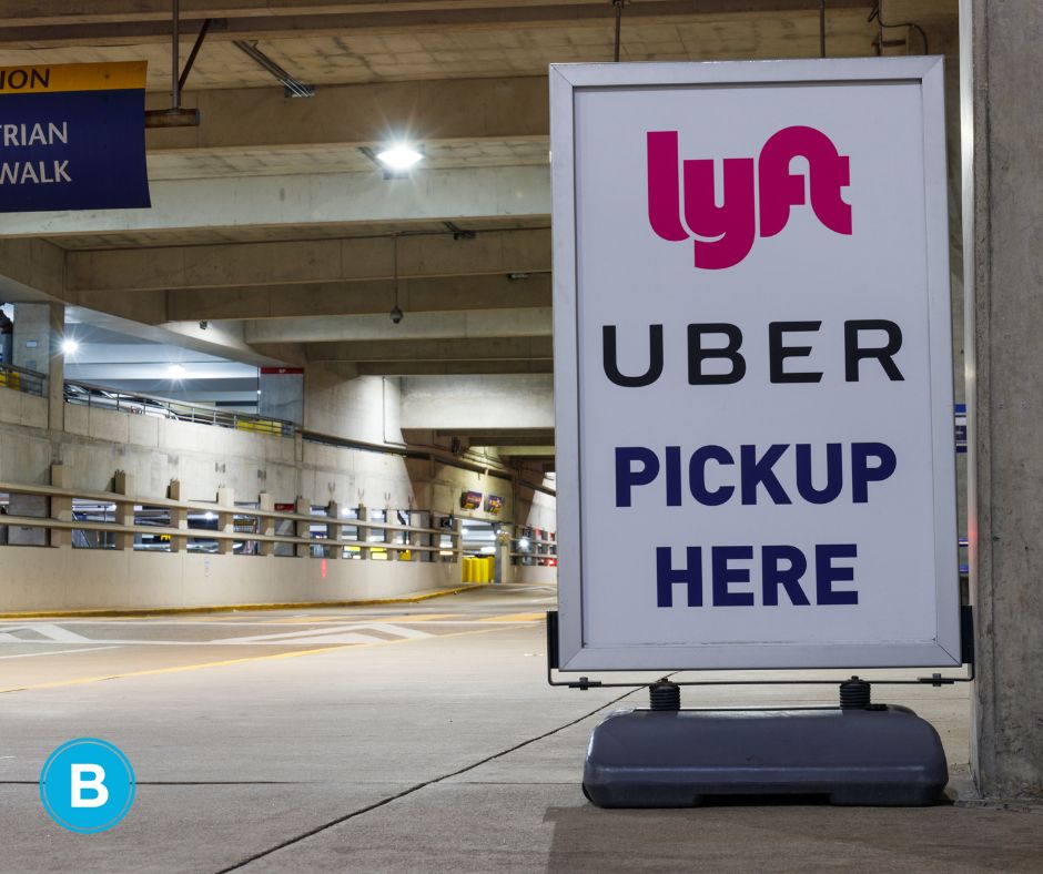A sign in a parking deck designating an Uber and Lyft pickup location.