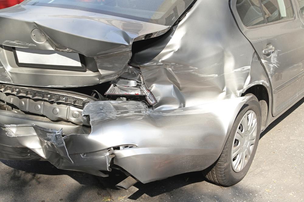The crushed rear-end of a car after a rear-end truck accident in Florida. Find out what injury victims need to know.