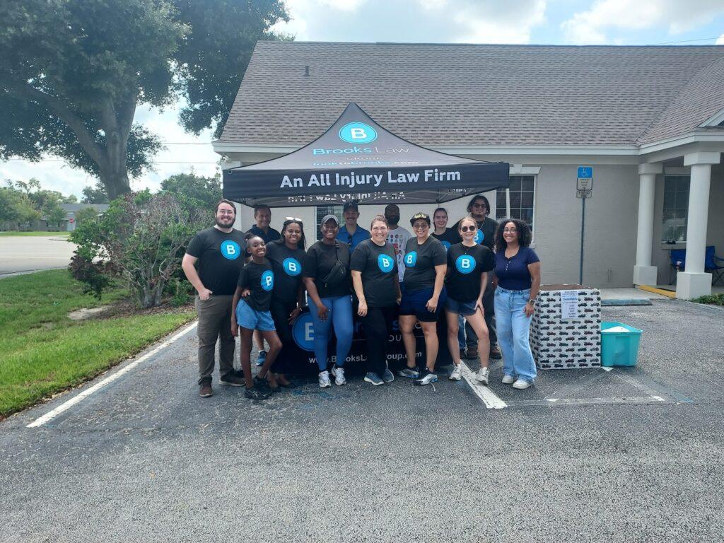 Brooks Law Group team members and supporters under the firm's tent at the pet adoption event in Winter Haven