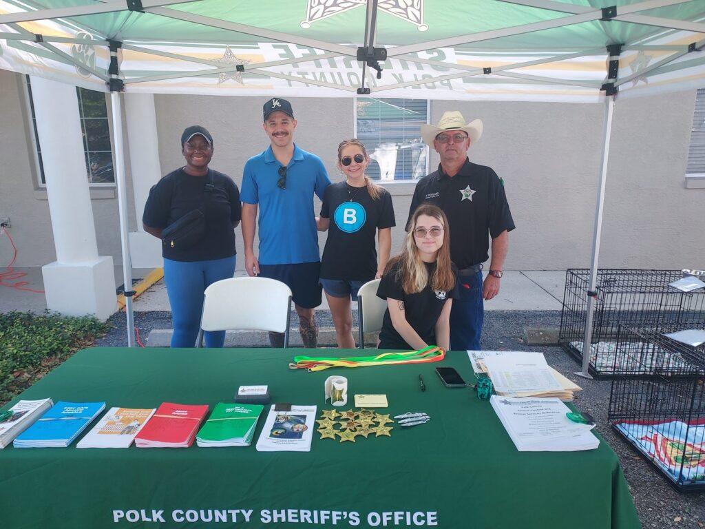 Brooks Law Group and Polk County Animal Control staff at the Polk County Sheriff's Office table during the pet adoption event